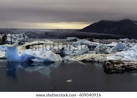 Icebergs are floating in the Glacier lagoon in Jokulsarlon during a sunset near the Black Beach (Diamond Beach) near Hofn in the south east of Iceland
