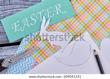 Patterned paper and scissors. Turquoise Easter card. Ideas for Easter school project.