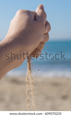 Hand and sand. Relaxing background.