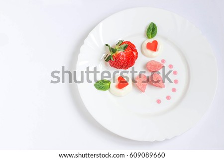 Delicate dessert for ladies with fresh strawberries, biscuit cake, cream and jelly. Gourmet food. Served on Valentine's Day, Women's Day, Mother's Day