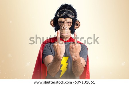 Superhero monkey man making horn gesture on ocher background