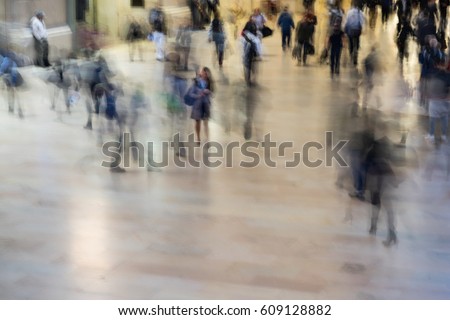Fast moving crowd of commuters at Grand Central Station in New York. Motion blur of figures headed to their jobs. Working life in the city. Royalty-Free Stock Photo #609128882