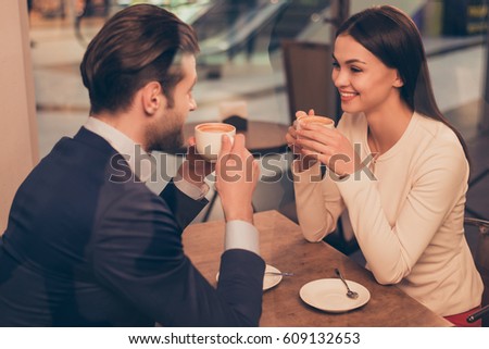Portrait of lovely romantic couple sitting in a cafe with coffee. Royalty-Free Stock Photo #609132653