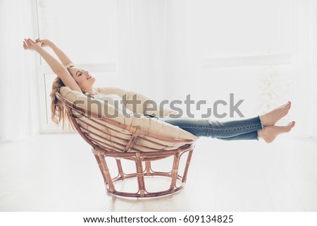 Happy cute pretty woman lying in the armchair on the weekend. Royalty-Free Stock Photo #609134825