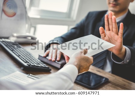 Businessman refusing money in the envelope - anti bribery and corruption concepts Royalty-Free Stock Photo #609147971