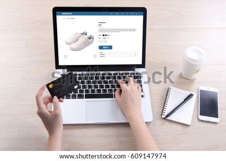 Woman use ecommerce webshop for buy shoes with holding credit card Royalty-Free Stock Photo #609147974