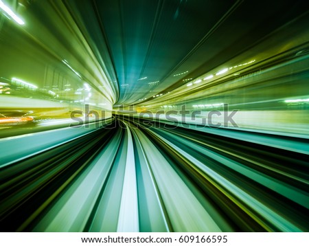 Green background of train moving through future rail tunnel bridge with blurred motion showing rapid movement. Royalty-Free Stock Photo #609166595