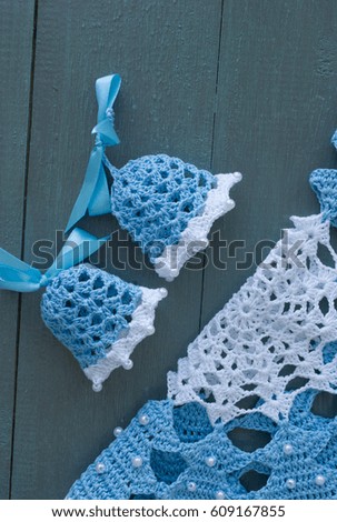 Blue knitted bells on a wooden background