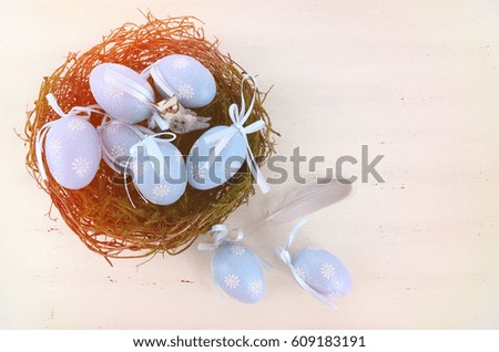 Happy Easter blue and white theme eggs on white wood table background, with applied light leak filters. 