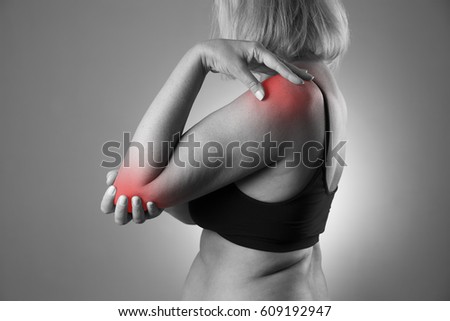 Pain in joint, care of female hands, ache in woman's body, black and white photo with red spots