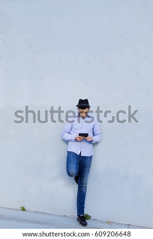 young man with the phone on the street