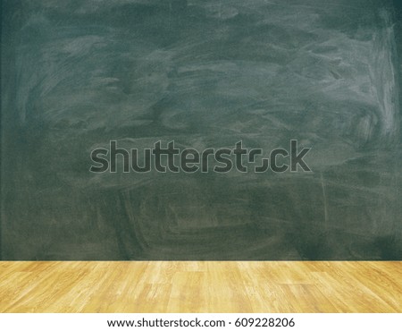 Room with blank chalkboard wall and wooden floor. Mock up. Education concept