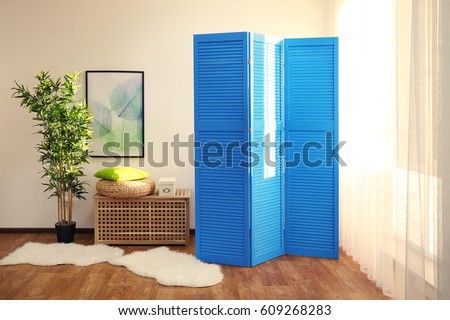 Light room interior with blue folding screen