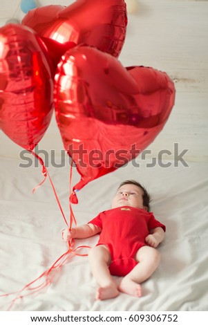 cute baby with heart shaped ballons