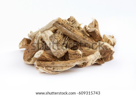 Pile of dried and sliced marshmallow root (Althaea officinalis) isolated on white background Royalty-Free Stock Photo #609315743