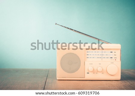 Retro radio front mint green background. Vintage style filtered photo