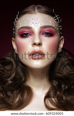 Beautiful girl with perfect art makeup and pearl beads. beauty face. Photos shot in the studio.