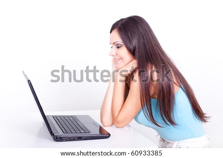 Portrait of a beautiful young female using laptop against white background