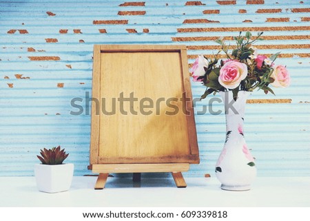 picture frame , flower and plant in wood background. 