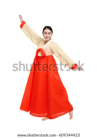 Beautiful young woman in Korean traditional costume dancing on white background Royalty-Free Stock Photo #609344423