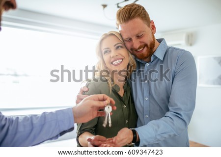 Happy couple moving in a new house. Royalty-Free Stock Photo #609347423