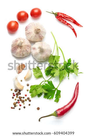 Mediterranean food and drink healthy lifestyle concept: Italian herbs vegetables and spices. Top view. Isolated on white. Cherry tomatoes parsley garlic and peppers. Royalty-Free Stock Photo #609404399