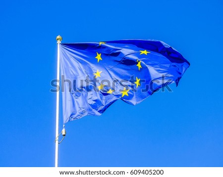 European Union flag flying in front of bright blue sky