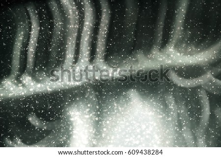 Abstract silver background with white particles. Round bokeh or glitter lights. Template for design