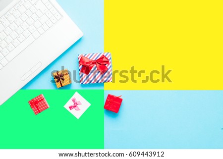 cute gifts and silver laptop on the wonderful colorful  background in pop art style