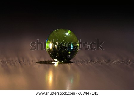 The Colored Glass Marbles | Green mica marble in dark background