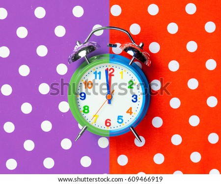 photo of cool alarm clock on the wonderful colorful background in pop art style 