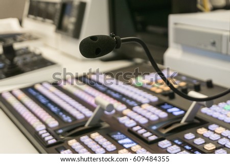 Video switch of Television Broadcast with blurry background, control broadcasts in recording studio., Photo of the TV broadcasting working with video and audio mixer., close up at microphone.