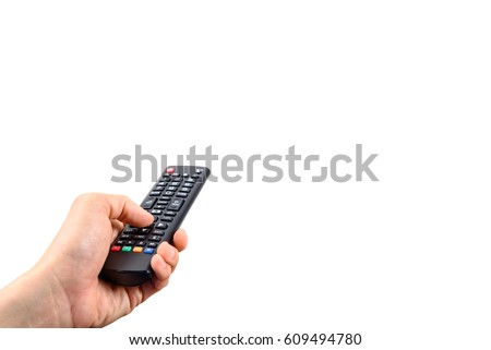 Man holds a black remote control in a left hand. A remote control is a component of an consumer electronic device used to operate the device wirelessly from a distance. Isolated on white background. 
