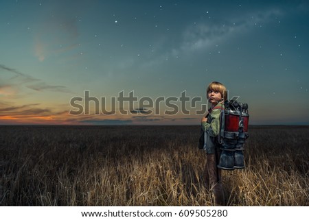 Little boy with a backpack outdoors