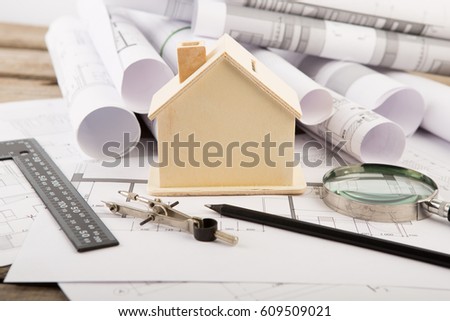 Workplace of architect - construction drawings,model of a house and tools