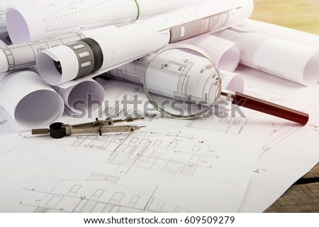 Workplace of architect - construction drawings and tools on the table