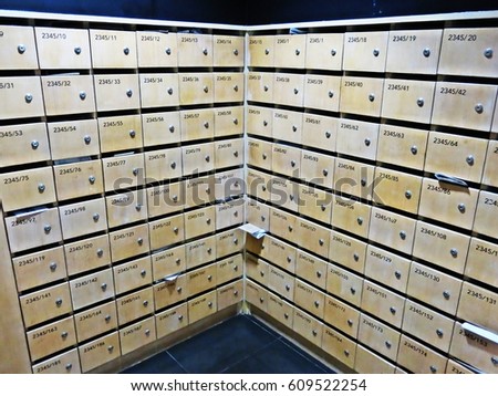 Multiple wood mailboxes at lock with key