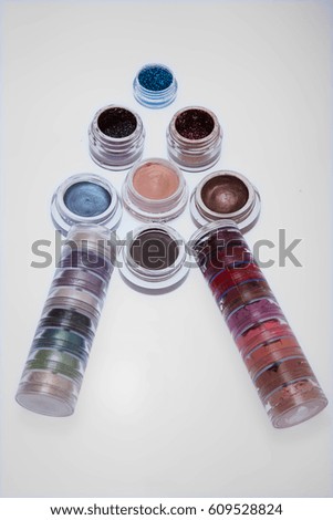 collection of cosmetics for make-up artist. Powder, pigments, glitter, brushes and eyeliner. studio photo on a wooden background with free space.