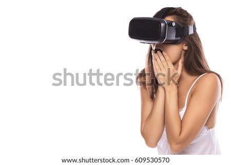 Woman is using VR headset on white background
