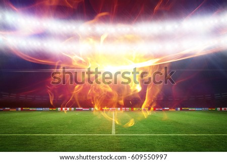 Ball of fire against football pitch under blue lights 3d