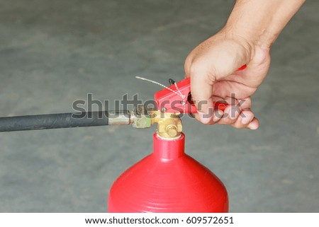 Male hands presses the trigger fire extinguisher, Closeup
