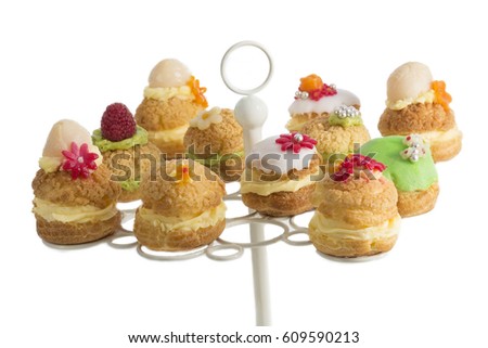 Cream puff cakes or profiterole filled with whipped cream served with fruits