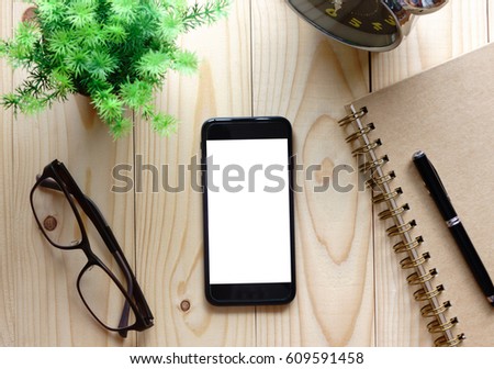 Office desk table with blank screen smart phone