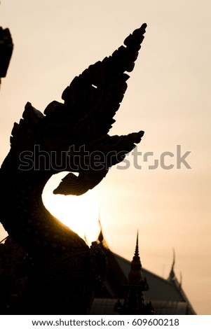 Silhouette pictures,The serpent at the temple with sunset (golden background)