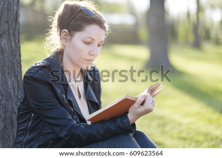 Woman with a book in spring park