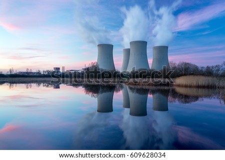 Nuclear power plant after sunset. Dusk landscape with big chimneys. Royalty-Free Stock Photo #609628034