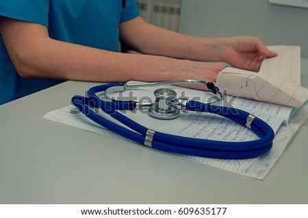 Stethoscope with clipboard and Laptop on desk,Doctor working in hospital writing a prescription, Healthcare and medical concept,test results in background,vintage color,selective focus