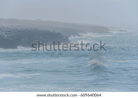 The coast of the Atlantic Ocean during a strong fog and a storm. Cascais, Portugal. Background.
