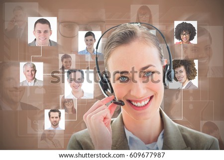 Smiling businesswoman with headset looking at camera against brown background