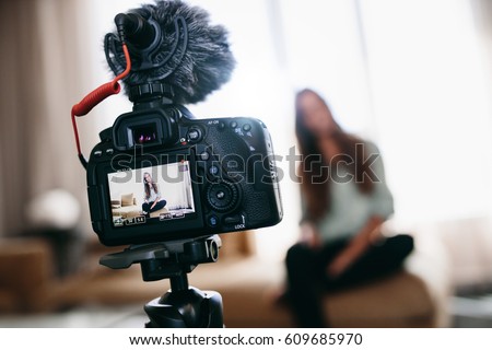 Woman recording content for her vlog . Camera screen showing the woman recording her vlog. Royalty-Free Stock Photo #609685970